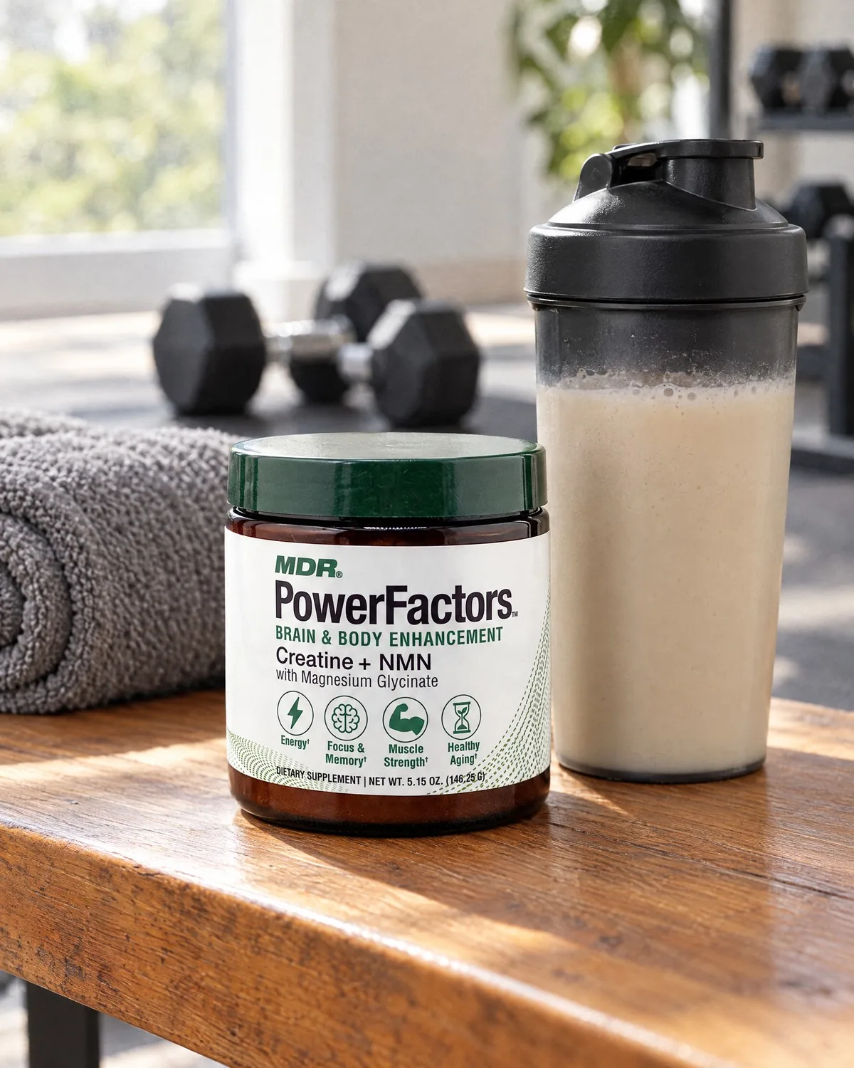 PowerFactors jar on a wooden bench next to a protein shake, dumbbells behind