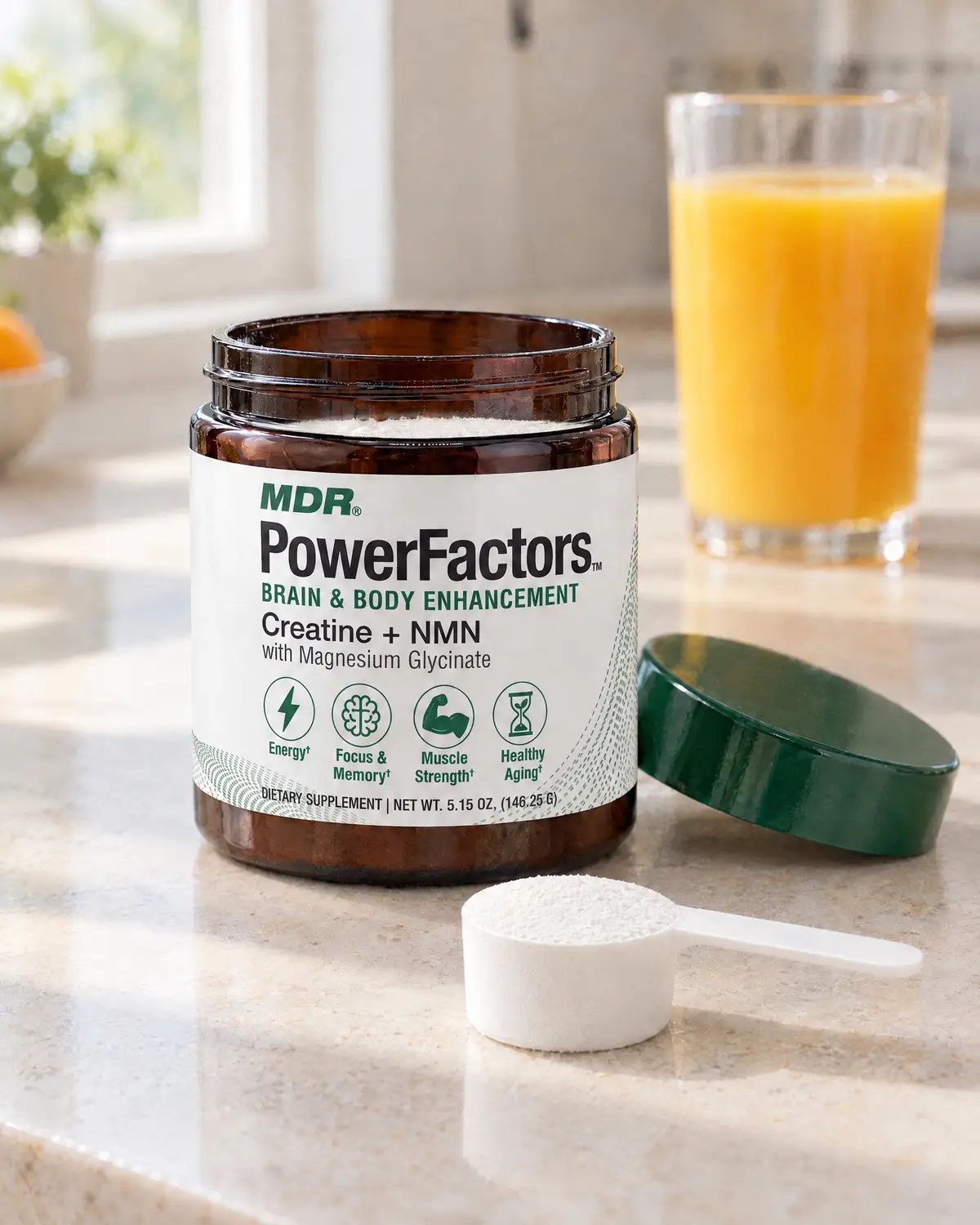 PowerFactors jar and scoop on a kitchen counter with a glass of orange juice